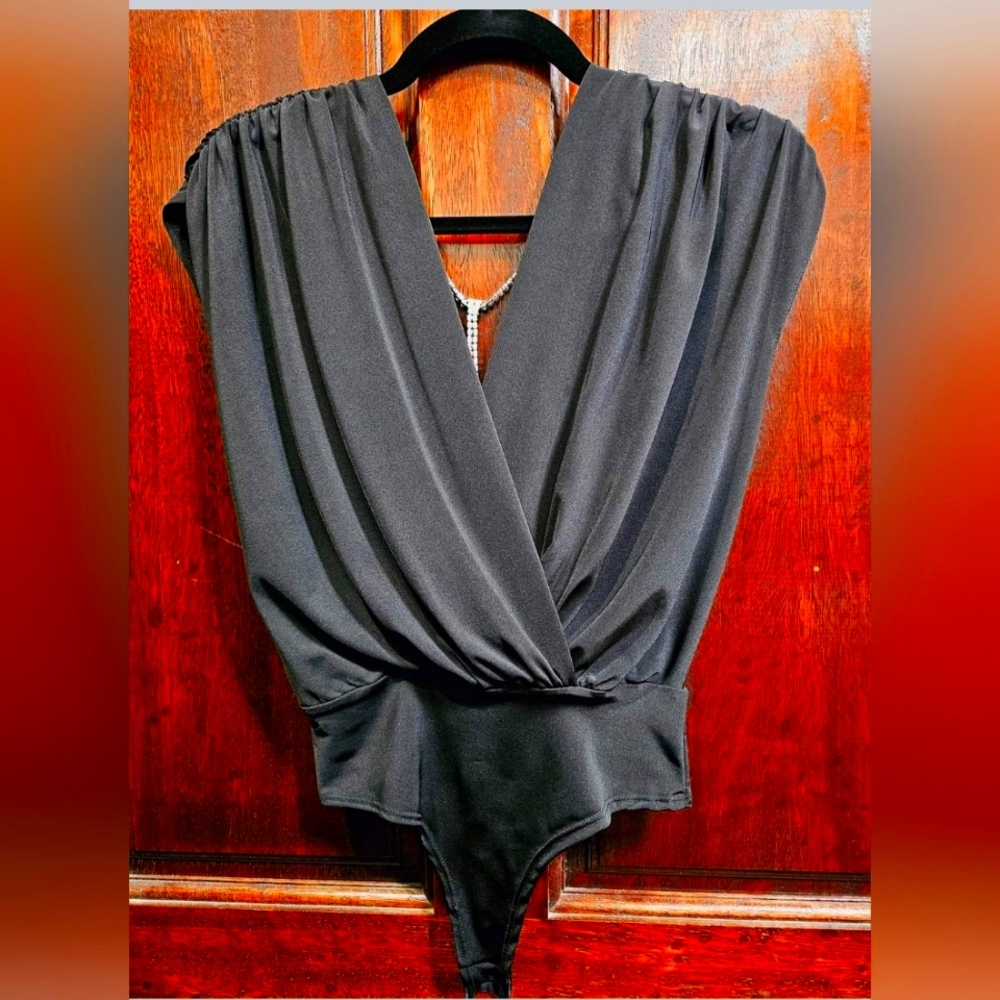 Size medium, black bodysuit with rhinestones down the back.no tag never worn